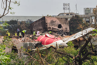 An investigation team inspects the wreckage of Air India flight 171 a day after it crashed in a residential area near the airport, in Ahmedabad on June 13, 2025.