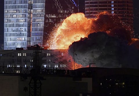 An explosion is seen during a missile attack in Tel Aviv, Israel, Friday, June 13, 2025. 