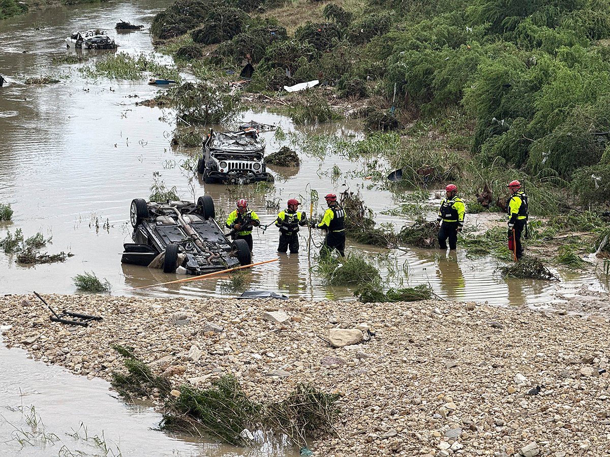 Authorities respond after vehicles were swept away by floodwaters in San Antonio, Texas, on Thursday, June 12, 2025. 