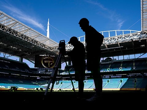 Workers get the pitch ready at the Hard Rock Stadium in Miami Gardens, Florida on June 13, 2025, on the eve of the Club World Cup 2025 Group A football match between Egypt's Al-Ahly and US Inter Miami. 