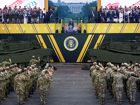 President Donald Trump participates in a reenlistment ceremony for Army soldiers during a military parade commemorating the Army's 250th anniversary Saturday, June 14, 2025, in Washington. 