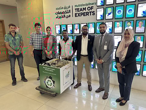 Aster Volunteers with an e-waste collection box at Aster Hospital Sharjah.
