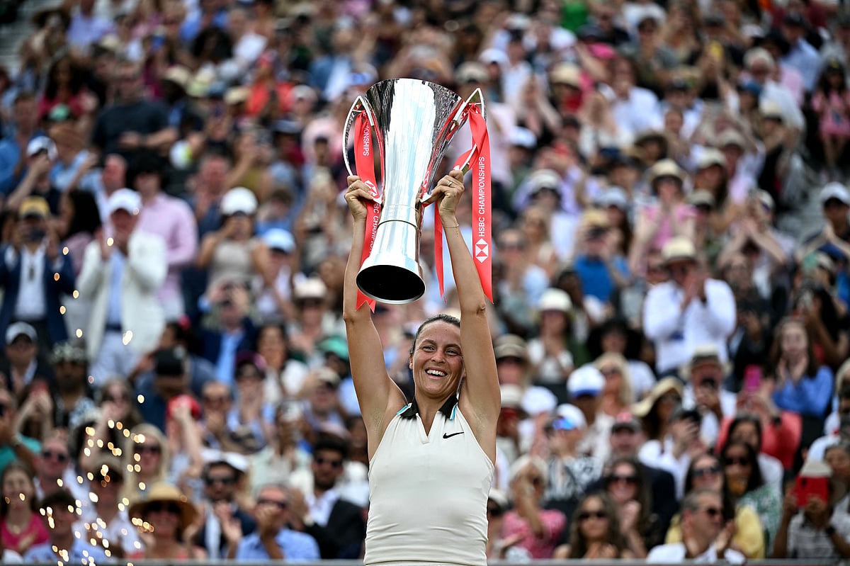 German player Tatjana Maria lifts the trophy after winning against US player Amanda Anisimova during their women's singles final tennis match on the last day of the HSBC WTA tennis Championships at Queen's Club in west London on June 15.
