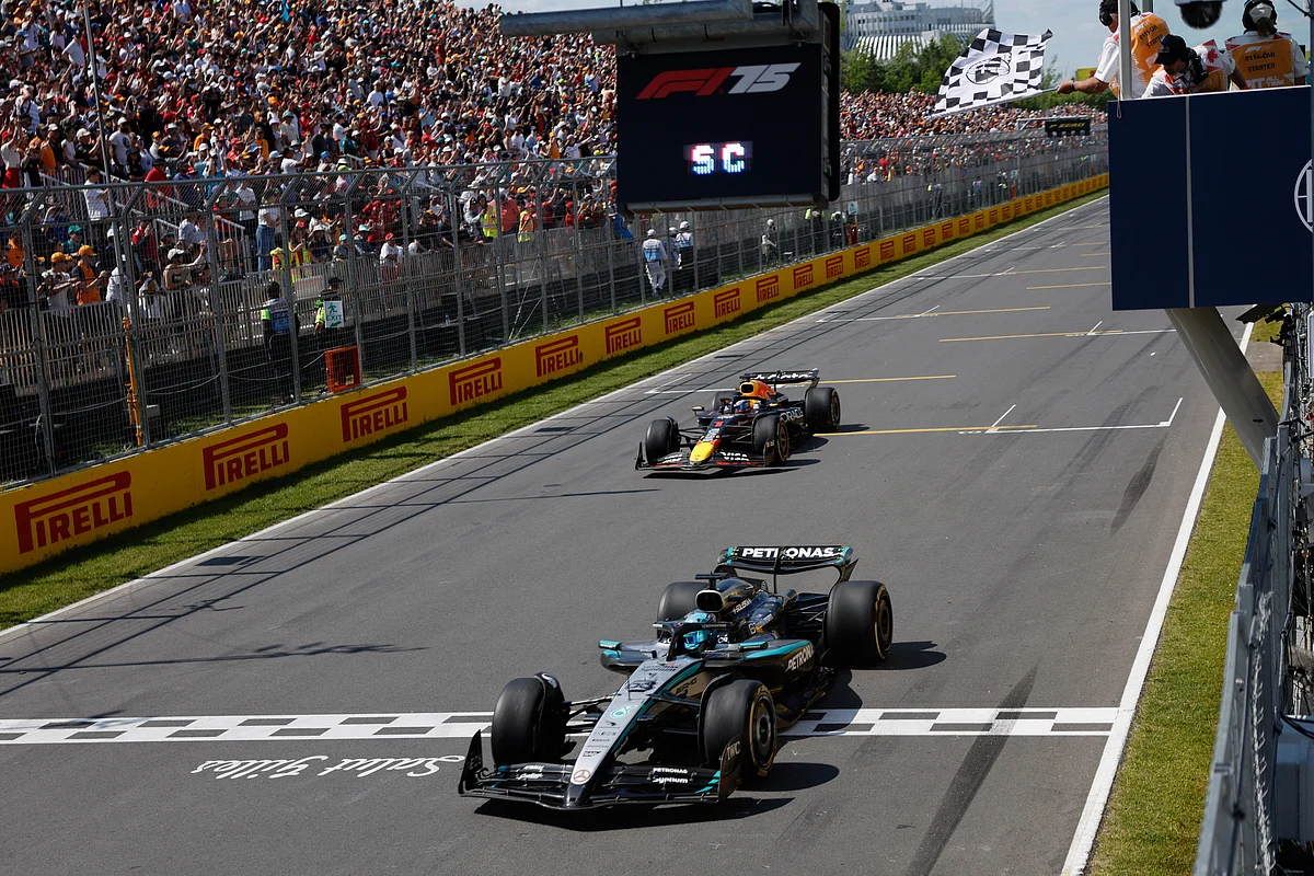 Mercedes' British driver George Russell crosses the finish line as he wins the race, followed by Red Bull Racing's Dutch driver Max Verstappen in second place, during the 2025 Formula 1 Grand Prix du Canada at Circuit Gilles-Villeneuve in Montreal, Canada, on June 15, 2025.