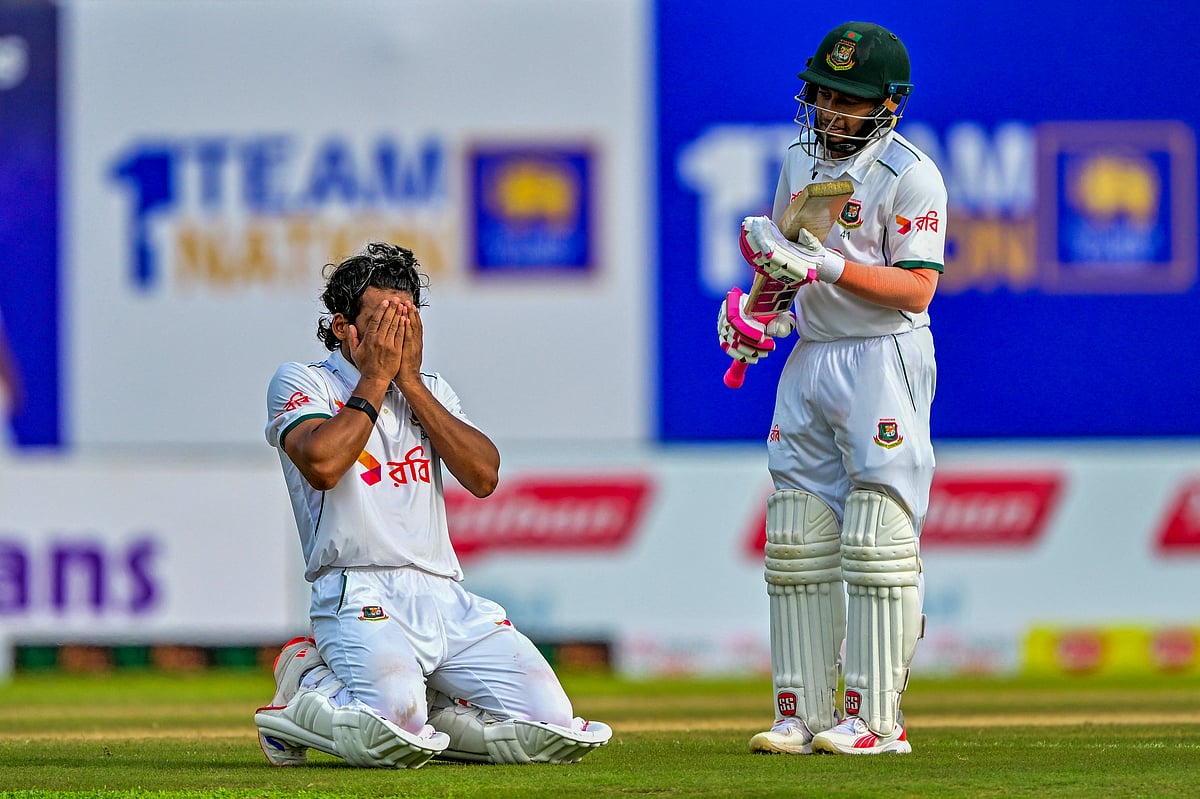 Bangladesh's captain Najmul Hossain Shanto (left) celebrates after scoring a century (100 runs) as teammate Mushfiqur Rahim looks on during the first day of the first Test cricket match against Sri Lanka at the Galle International Cricket Stadium in Galle on June 17.