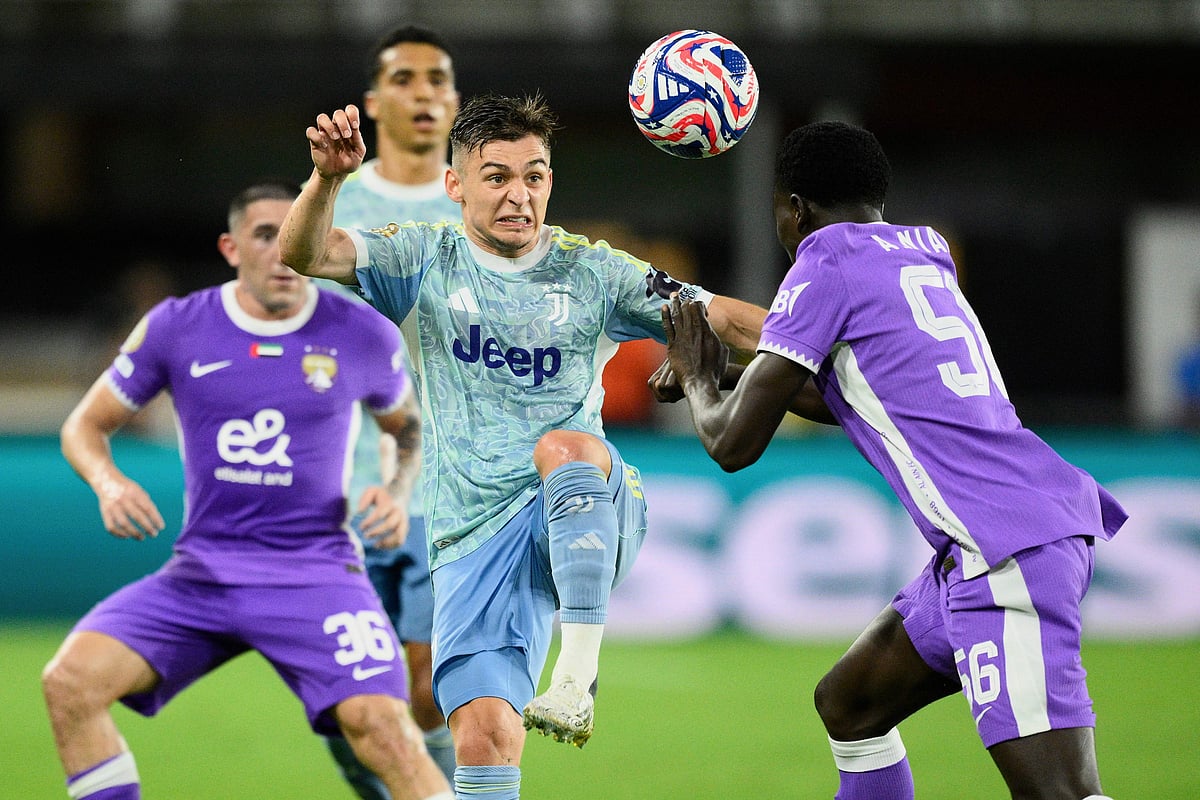 Juventus' Francisco Conceicao and Al Ain's Amadou Niang (right) compete for the ball during the Club World Cup Group G football match against Al Ain in Washington, Wednesday, June 18, 2025.