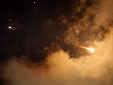 Rocket trails are seen in the sky above the Israeli coastal city of Netanya amid a fresh barrage of Iranian missile attacks on June 21, 2025. 