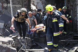 This photo taken and handout on June 24, 2025 by the State Emergency Service of Ukraine shows first responders evacuating a wounded person from the rubble of a building following a Russian missile strike in the eastern Ukrainian city of Dnipro.