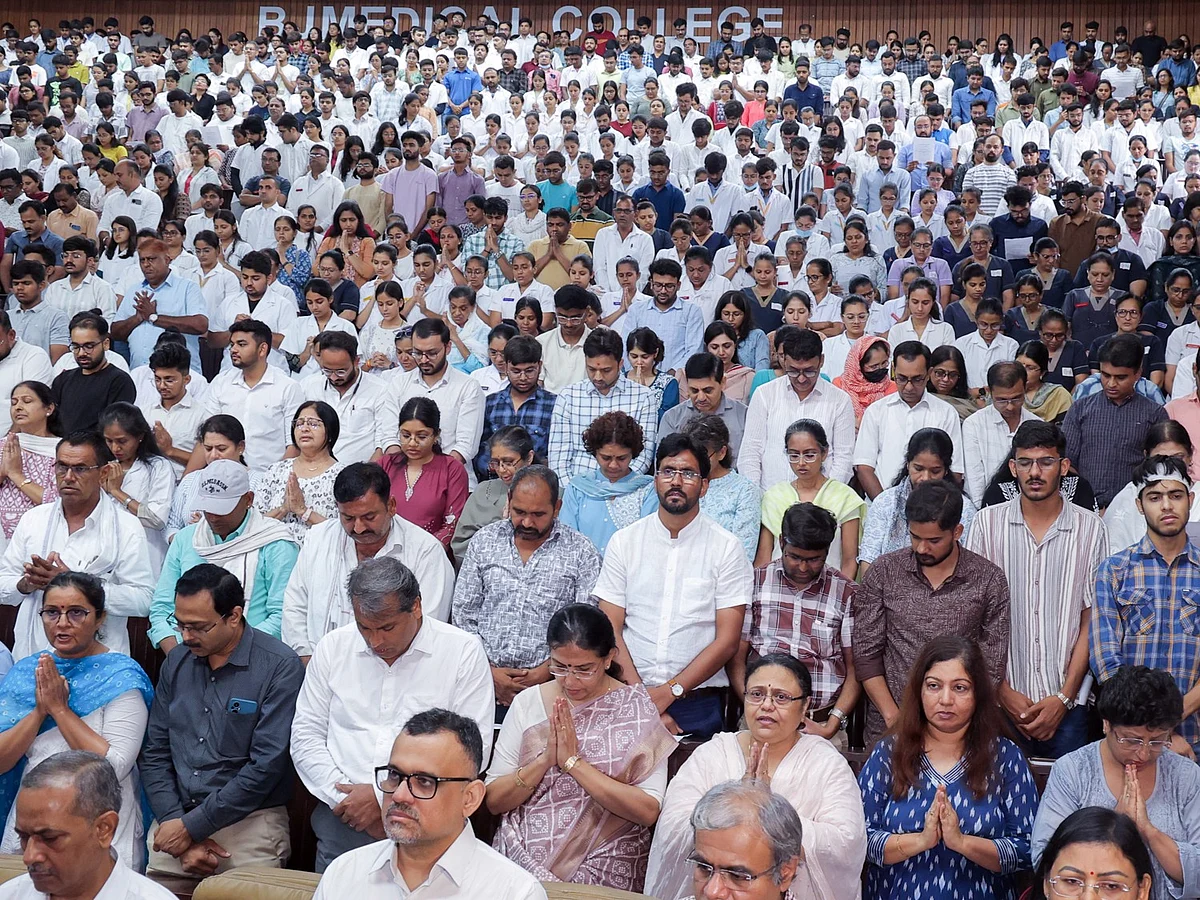 Families of the deceased, the injured, students, and teachers during the prayer gathering at BJ Medical College.