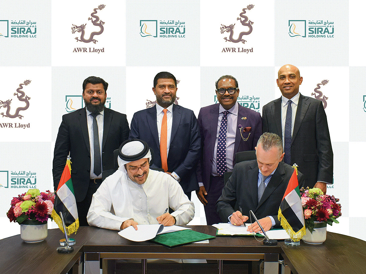 Sitting from left: Ahmed Khalaf Al Otaiba and Alexander Wood sign the MoU; From left (top row): Ahamed Khan, Mohamed Rusan Fyroze, Udaya Indrarathna, Charaka Sumanasekara
