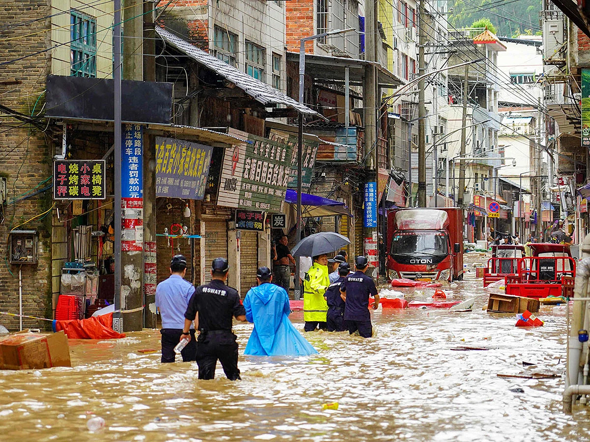 Rescue workers check a flooded street in Congjiang, in China’s southwest Guizhou province.