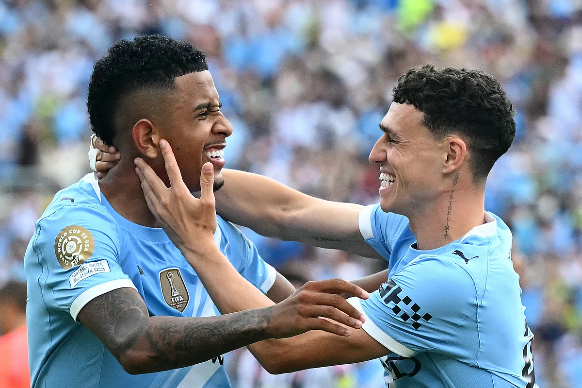 Manchester City's Phil Foden (right) celebrates with teammate Savinho after scoring his team's fourth goal during the FIFA Club World Cup 2025 Group D football match against Italy's Juventus in Orlando on June 26, 2025.