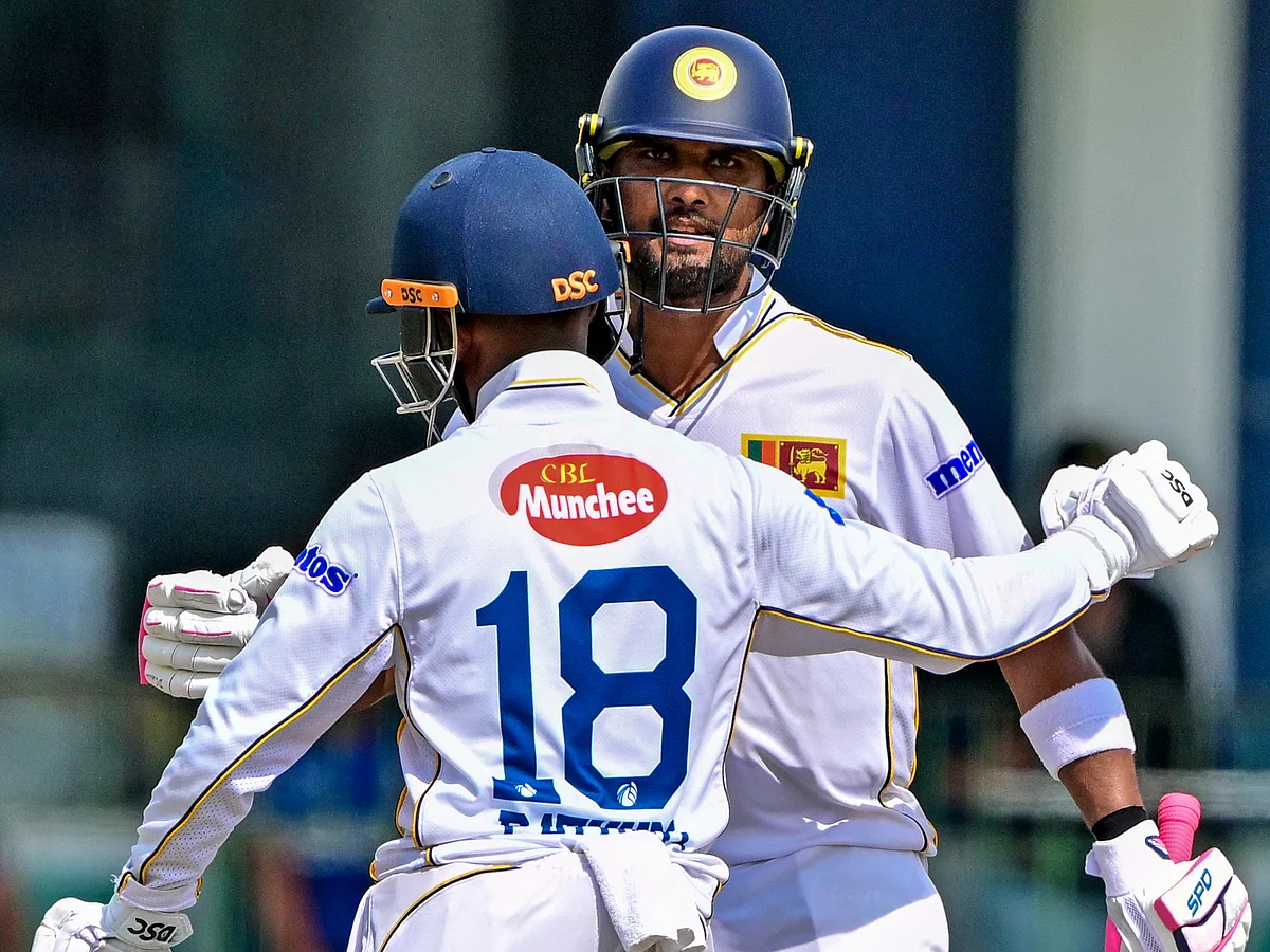 Sri Lanka's Dinesh Chandimal (right) celebrates with Pathum Nissanka after reaching a half-century during the second day of the second Test against Bangladesh in Colombo on June 26, 2025.