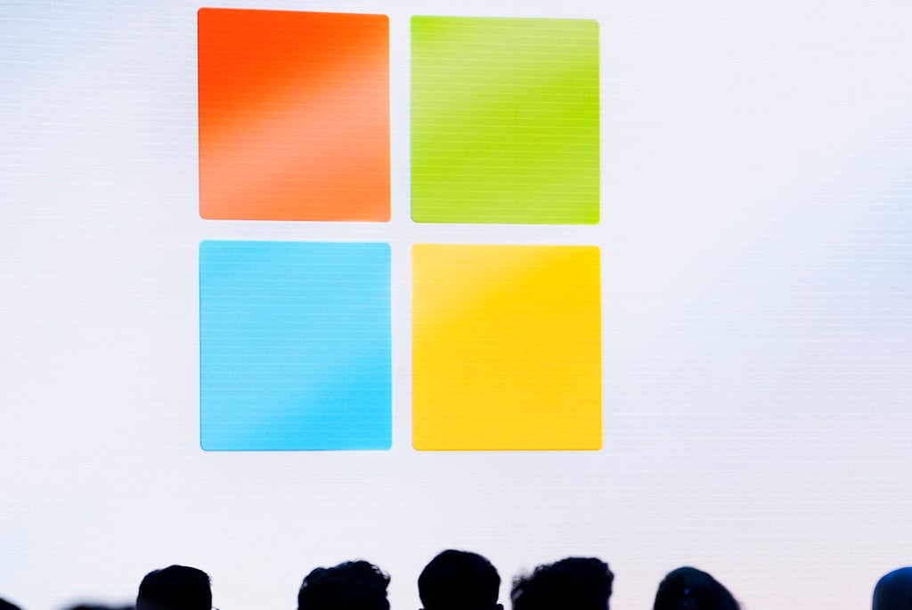 FILE - A Microsoft logo is seen on a screen as people listen at an event at Microsoft headquarters, May 20, 2024, in Redmond, Wash. (AP Photo/Lindsey Wasson, File)