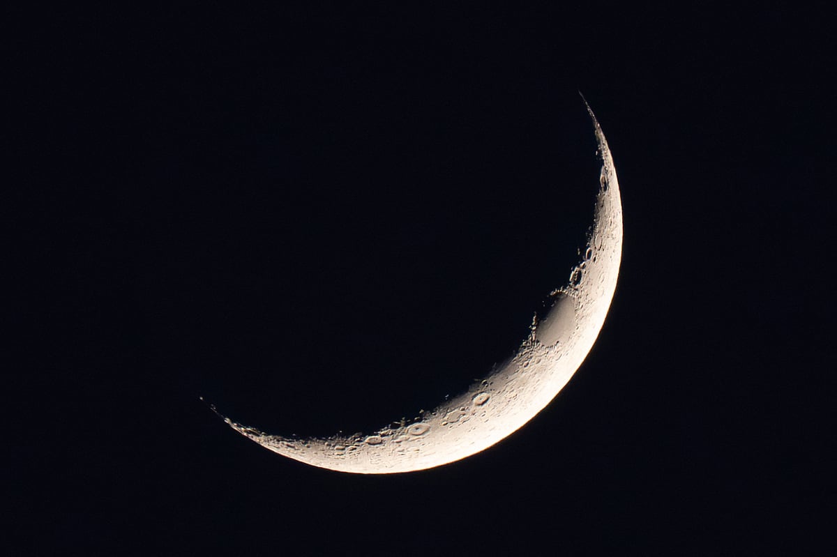 The crescent moon is seen above the southern Iraqi city of Basra.