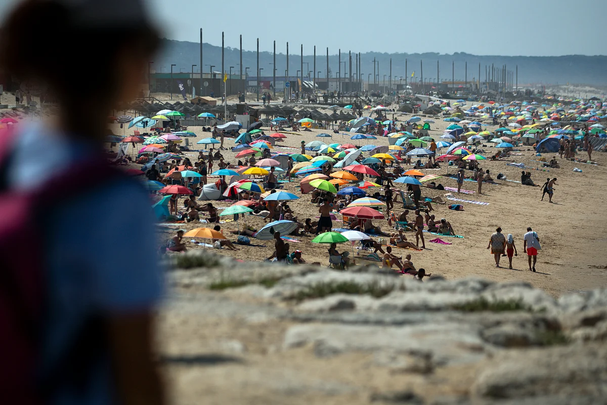 This picture shows people on Costa da Caparica beach in Almada, near Lisbon, during the first heatwave of the year, on June 29, 2025.