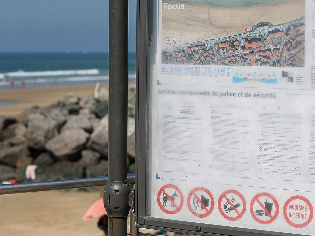 A poster advertises on banned activities, including smoking, on the beach, Monday, June 30, 2025 in Hendaye, southwestern France.  