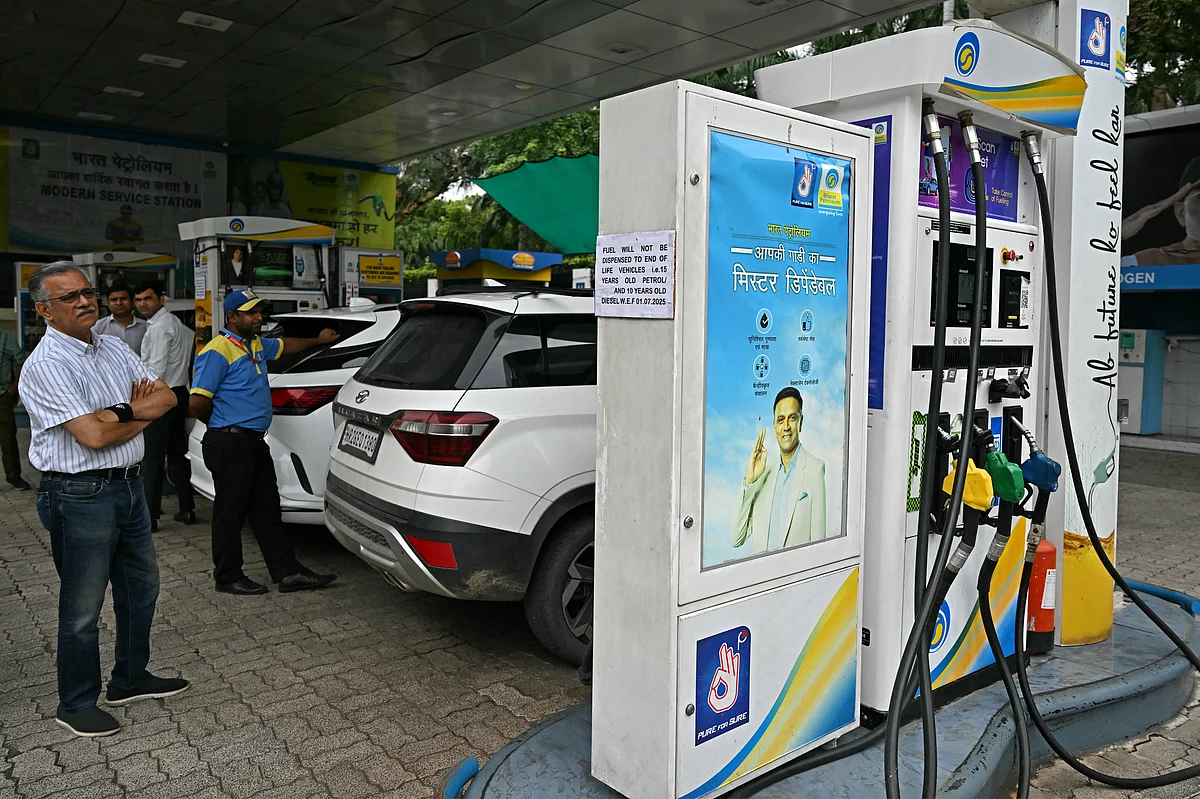 A man reads a notice announcing the ban on refuelling petrol cars older than 15 years and diesel vehicles older than 10 years, displayed at a gas station in New Delhi on July 1, 2025.