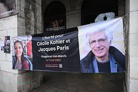 This photograph shows a banner depicting French Cecile Kholer and Jacques Paris detained in Iran for almost three years, during a rally for their release, in front of Bayonne town hall, southwestern France,on May 07,2025.