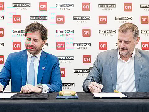 Ziad Melhem (left), CEO of CFI Financial Group, and Marcus Osborne, General Manager at Etihad Arena, sign the partnership agreement
