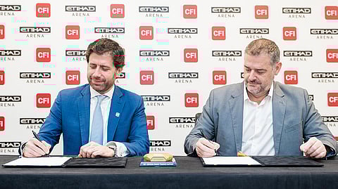 Ziad Melhem (left), CEO of CFI Financial Group, and Marcus Osborne, General Manager at Etihad Arena, sign the partnership agreement