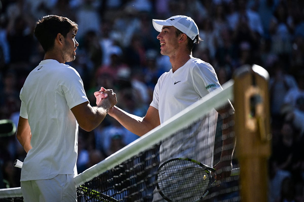 Winner Spain's Carlos Alcaraz (left) congratulates Britain's Oliver Tarvet at the end of their men's singles second round tennis match on the third day of the 2025 Wimbledon Championships at The All England Lawn Tennis and Croquet Club in Wimbledon, southwest London, on July 2, 2025.