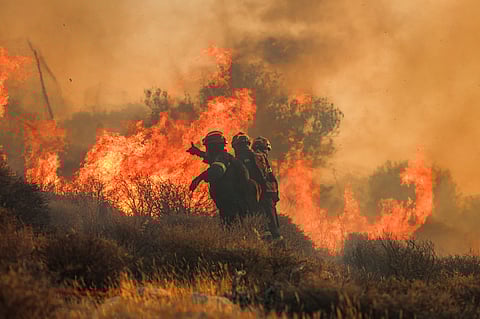 Firemen battle with a wildfire that broke out in Ierapetra at the southern Greek island of Crete, on July 3, 2025.