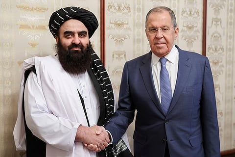 In this photo released by Russian Foreign Ministry Press Service on Oct. 4, 2024, Russian Foreign Minister Sergey Lavrov, right, and Acting Foreign Minister of Afghanistan's Taliban movement Amir Khan Muttaqi pose for a photo prior to their talks in Moscow, Russia.