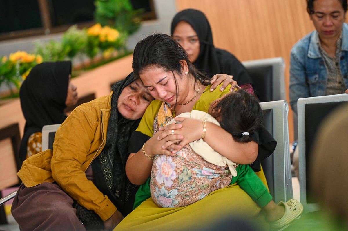 Family members and relatives wait for updates on the search operation of at least 61 people who were missing after a ferry sank off the popular Indonesian resort island of Bali, at Ketapang Port in Banyuwangi, East Java on July 3, 2025.