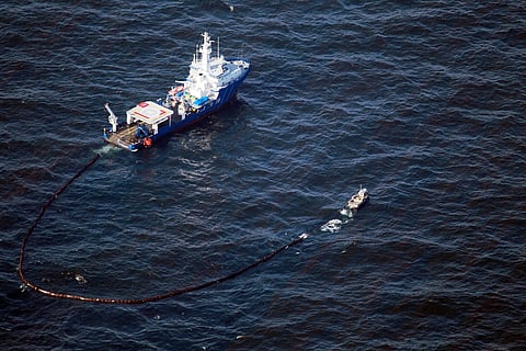 Boats pull an oil boom behind them as they skim the oil from the surface near where the Deepwater Horizon oil platform sank as work continues to contain the leak on May 9, 2010 in the Gulf of Mexico.