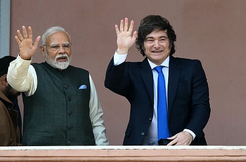 India's Prime Minister Narendra Modi and Argentina's President Javier Milei wave on the balcony of the Casa Rosada government palace after a meeting in Buenos Aires, on July 5, 2025.
