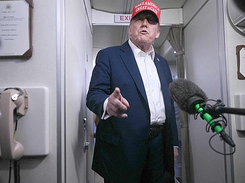 US President Donald Trump speaks to journalists aboard Air Force One after departing Joint Base Andrews, Maryland on his way to Bedminster, New Jersey on July 4, 2025. A