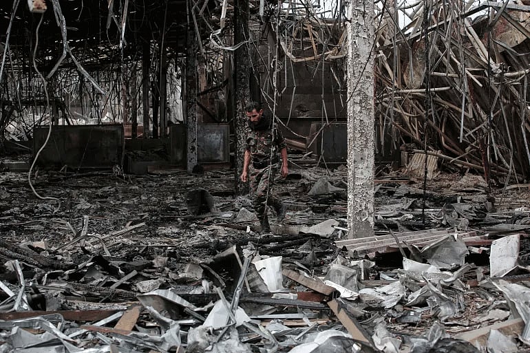 A Yemeni officer inspects the damage following Israeli airstrikes on Sanaa International Airport on May 7, 2025