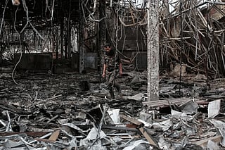 A Yemeni officer inspects the damage following Israeli airstrikes on Sanaa International Airport on May 7, 2025