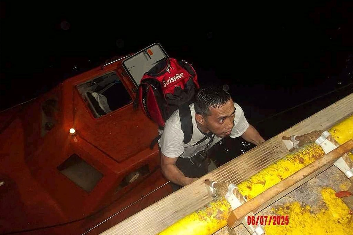 A handout photo provided by the UAE Ministry of Foreign Affairs reportedly shows members of the Greek owned, Liberian-flagged "Magic Seas" commercial vessel climbing on board the Safeen Prism, after being rescued following an attack that forced them to abandon ship, in the Red Sea on July 6, 2025.  In a statement, the Ministry of Foreign Affairs (MoFA) confirmed that the UAE's response operation successfully rescued all 22 individuals aboard the vessel, including crew and security personnel.