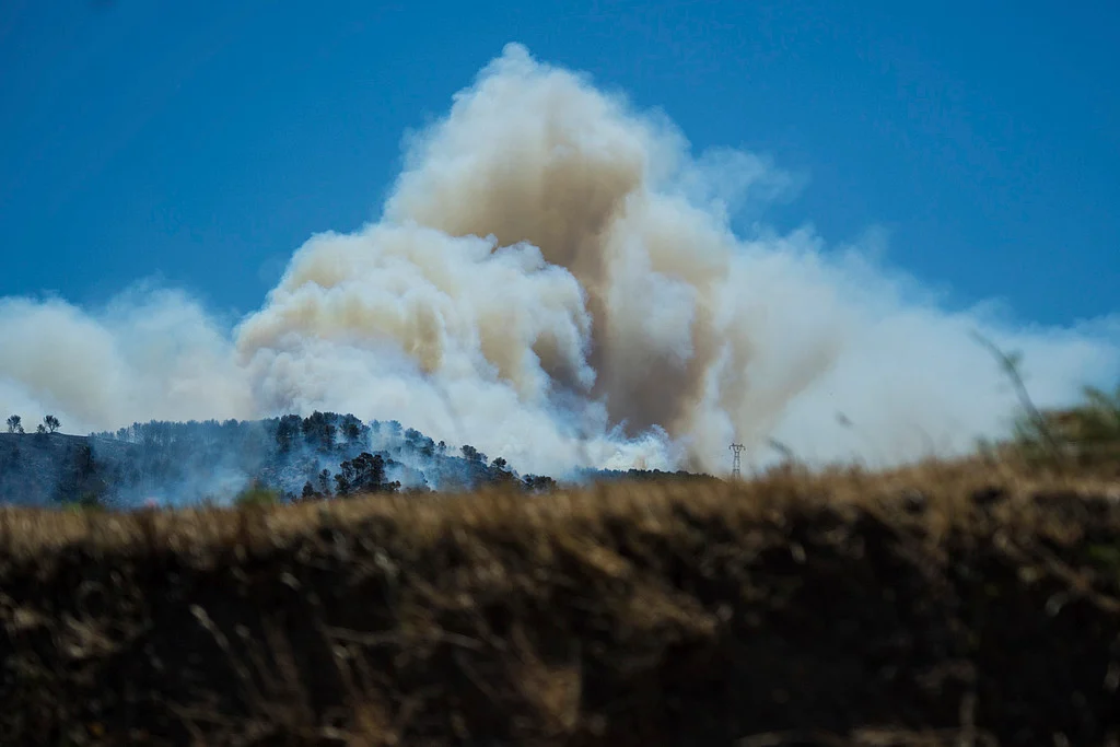 This photo provided by the fire brigade Pompiers13, shows a cloud of smoke over hills near Marseille, southern France, Tuesday, July 8, 2025. 