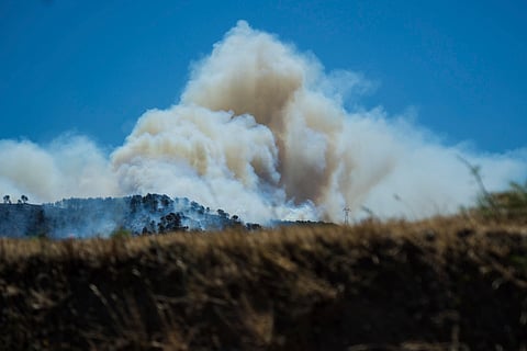 This photo provided by the fire brigade Pompiers13, shows a cloud of smoke over hills near Marseille, southern France, Tuesday, July 8, 2025. 