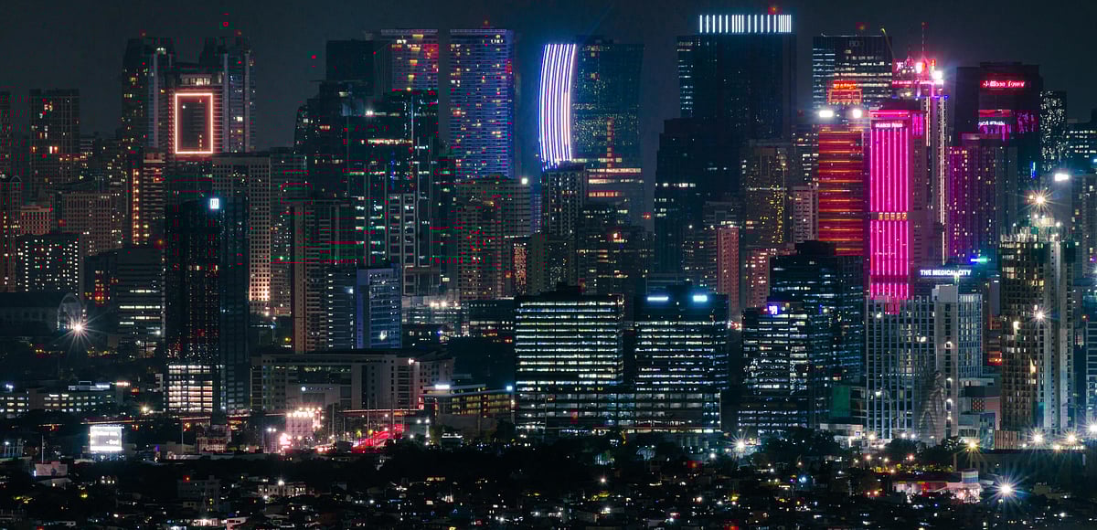 A night-time view of Manila skyscrapers. Despite a rise from $4,320 in 2023 to $4,470 in 2024 in gross national income (GNI) per capita, the Philippines was $26 short of the minimum upper middle income status threshold of $4,496. 