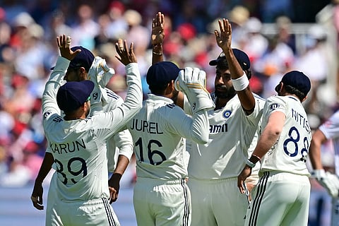 India's Jasprit Bumrah (second from right) celebrates with teammates after bowling Joe Root .