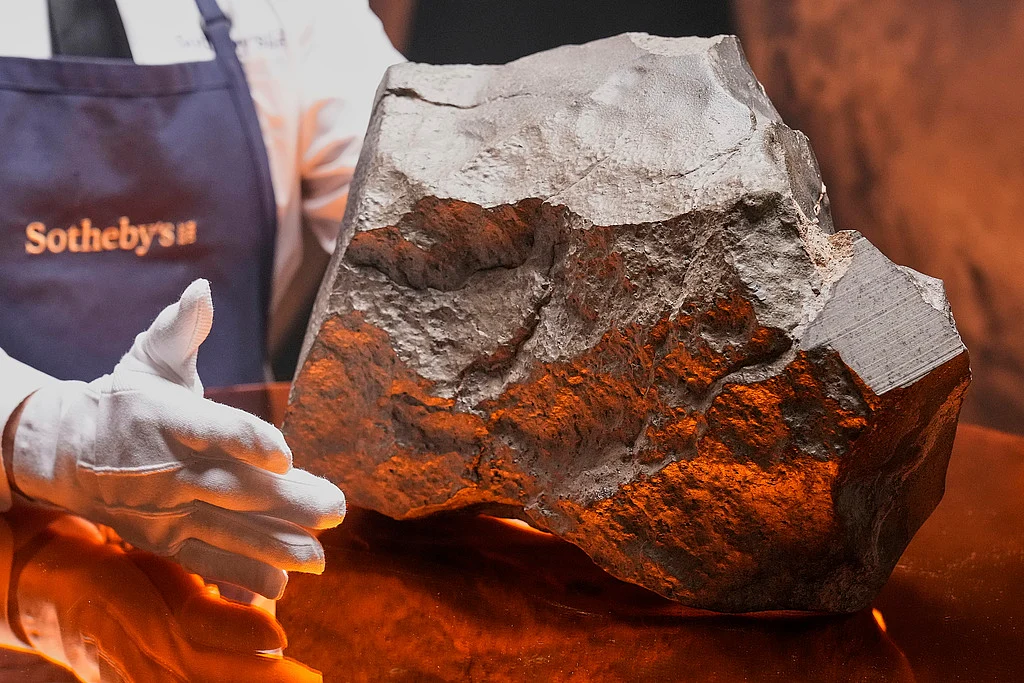 A Martian meteorite, weighing 54.388 lbs. (24.67 kg), said to be the largest piece of Mars on Earth, estimated at $2 - 4 million, is displayed at Sotheby's, 
