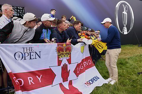 Rory McIlroy of Northern Ireland signs autographs on the 18th green following a practice round for the 2025 British Open golf championship at the Royal Portrush Golf Club, Northern Ireland, Monday, July 14, 2025.