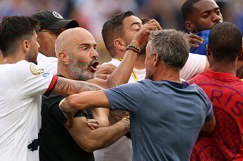 Enzo Maresca, head coach of Chelsea, engages with his PSG counterpart Luis Enrique following the FIFA Club World Cup 2025 final.