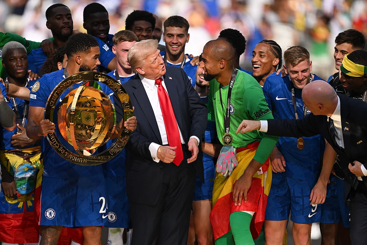 Reece James of Chelsea FC holds the Fifa Club World Cup trophy after their team's victory as American President Donald Trump interacts with Robert Sanchez  during the presentation ceremony on Sunday.