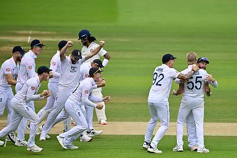 England's captain Ben Stokes (second from right) celebrates with teammates after  review shows India's KL Rahul was trapped LBW on the final day at Lord's on Monday.