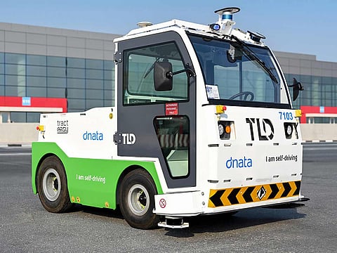 A self-driving electric baggage tractor.