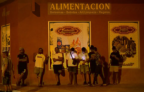 Youngsters stand in San Antonio district in Torre Pacheco, southeastern Spain, on July 15, 2025 as a rally has been called by far-right groups following four days of anti-migrant unrest.