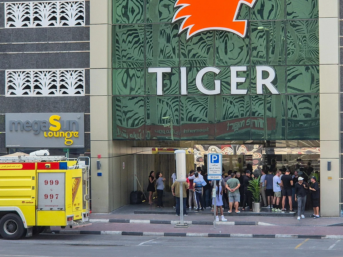 Residents gather outside the 67-storey Marina Pinnacle Tower in Dubai Marina.
