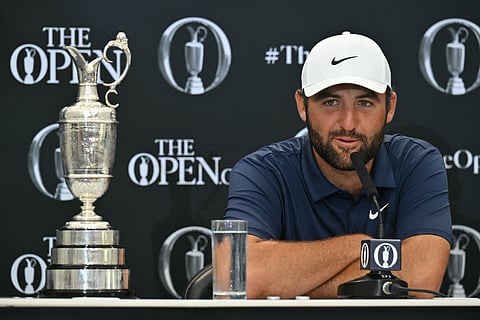 US golfer Scottie Scheffler with the Claret Jug, the trophy for the Champion golfer of the year beside him, holds a press conference after his victory in the 153rd Open Championship at Royal Portrush golf club in Northern Ireland on July 20, 2025.