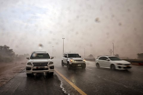 Rain pours over Al Ain Road, as drivers move cautiously through the downpour.