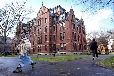 People walk between buildings on Harvard University campus, Dec. 17, 2024, in Cambridge, Massachusetts. 